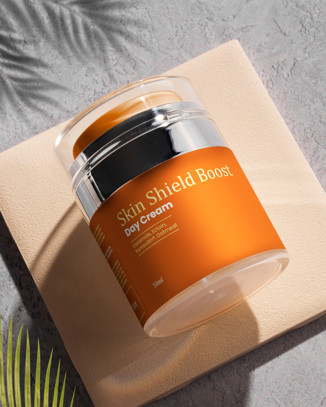 A jar of Treasure9 Skin Shield Boosting Day Cream displayed on a textured surface with a shadow cast across the frame. Moisturises and protects natural skin barrier. Contains Vegetable Squalane, Ectoin, Vitamin C Complex. Australian Made. Hydrating day cream Australia, clean face moisturizer, moisturiser. _Hydrating_day_cream_Australia_clean_face_moisturizer_moisturiser
